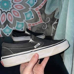 Black and white slip on vans.